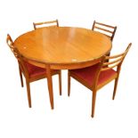 Teak G-Plan round extending dining table on tapering supports and four dining chairs with triple