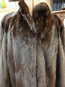 Dark full-length mink coat with bell sleeves and cuffs, silk lining
