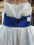 1950's chiffon evening dress printed with blue polka dots, sleeveless, dark blue satin band at the
