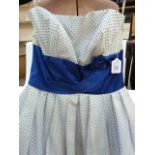 1950's chiffon evening dress printed with blue polka dots, sleeveless, dark blue satin band at the