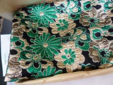 Three and a half yards of lurex in gold, green and silver on a black ground, with original receipt