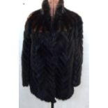Dark mink jacket, the fur laid diagonally, with brown and black mink diagonal stripes over the