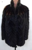 Dark mink jacket, the fur laid diagonally, with brown and black mink diagonal stripes over the
