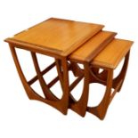 Nest of three G-Plan teak coffee tables with carved side supports, 49.5cm