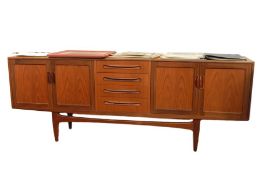 20th century G-Plan teak sideboard with four central drawers flanked by two cupboard doors with