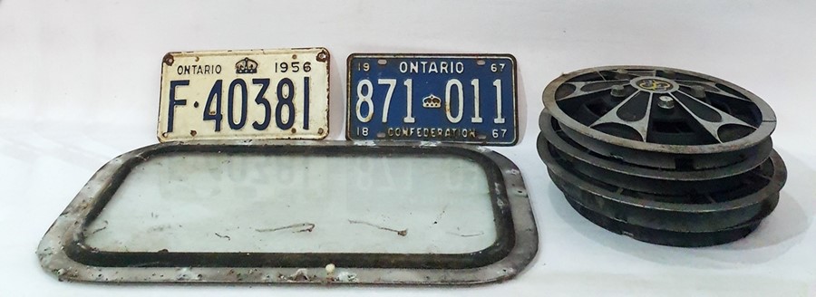 Four 500 S hubcaps, glass window from a car, 1956 Ontario number plate and a 1967 Ontario number