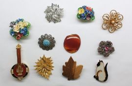 Quantity of costume jewellery to include brooches set with fishermen flies, assorted necklaces,
