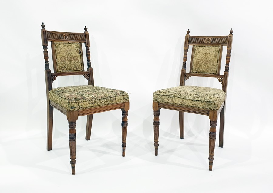 Set of four walnut-framed chairs with upholstered seats and backs, on turned front legs (4)