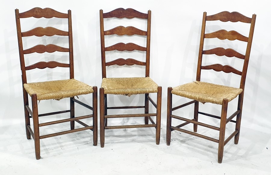 Set of four 20th century oak ladderback dining chairs with rush seats (4)