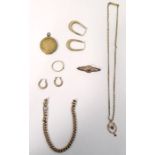 Gold bar brooch with pierced decoration set with a central garnet, marked 9ct, a pair of hoop