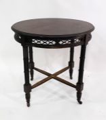 Stained mahogany circular centre table with moulded edge over carved and pierced frieze, raised upon