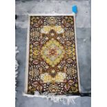 Eastern style rug with central medallion, brown foliate deorated border, 115cm x 60.5cm