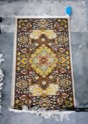 Eastern style rug with central medallion, brown foliate deorated border, 115cm x 60.5cm