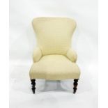 Cream ground upholstered low armchair on turned front supports to castors