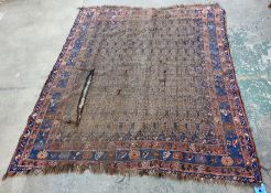 Eastern rug, the central field with repeating hook medallions, on a stepped border featuring flowers