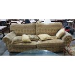 20th century three-seater sofa in a yellow ground foliate patterned upholstery