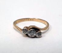 9ct gold and three-stone diamond ring, illusory set with tiny diamonds, in crossover