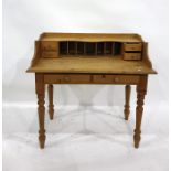 Old pine writing table, the back fitted with pigeonholes and four short drawers, two frieze drawers,