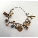 9ct gold fancy link charm bracelet hung with a 1902 gold half-sovereign, in 9ct gold coin mount, ten