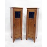 Pair of Art Nouveau style narrow single door cabinets, the square tops with moulded edges, above the