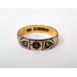 LOT WITHDRAWN 22ct two-colour gold band ring set with a central garnet flanked by two seedpearls,