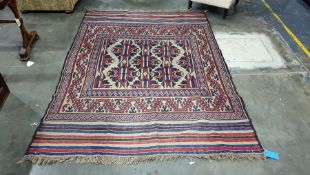 Cream ground Eastern rug decorated in red, blue and brown, 257cm x 190cm