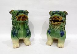 Two pottery model Dogs of Fo, green/blue glazed, 23cm high (2)