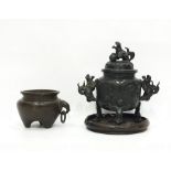 Chinese bronze censer, of circular form, decorated with landscape panels, with pierced cover, the