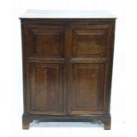 19th century oak two-door cupboard enclosing shelves, raised upon bracket feet, 72.5cm x 94.5cm