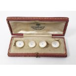 Set of four gold and mother-of-pearl dress buttons, each of circular form set with a central
