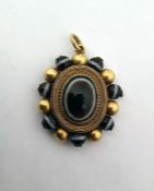 Victorian gold-coloured metal and banded onyx locket pendant, oval, with central oval banded