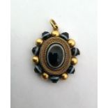 Victorian gold-coloured metal and banded onyx locket pendant, oval, with central oval banded