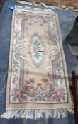 Chinese superwash peach ground rug, 134cm x 78cm