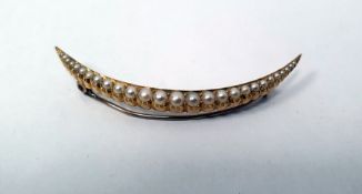 Late 19th/early 20th century gold crescent brooch set with graduated seedpearls, unmarked