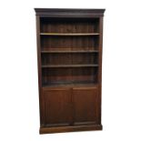 Old oak open bookcase with straight moulded cornice, adjustable shelves, cupboard below enclosing