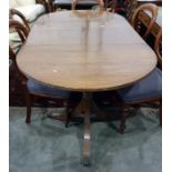 Regency mahogany dining table with single leaf, raised upon twin pedestal supports with swept fluted