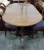 Regency mahogany dining table with single leaf, raised upon twin pedestal supports with swept fluted