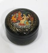 Circular Russian lacquer box painted with maidens sewing, with Russian script beneath, 6.5cm