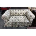 19th century Chesterfield-type drop arm sofa in beige ground foliate patterned upholstery, raised