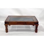 Eastern hardwood rectangular coffee table with glass top above the iron link decoration, on turned