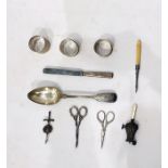 19th century fiddle pattern silver tablepoon, three silver napkin rings, a silver rattle with