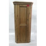 Old pine standing corner cupboard, the fielded panel door enclosing three shelves, width 67cm x