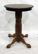 An oak high bar table with circular top, on substantial pedestal support with splay legs, diameter