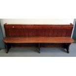 Victorian stained pine pew with panel back and solid seat, length 203cms