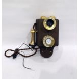 Early wooden-mounted wall telephone with brass fittings