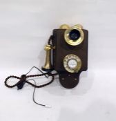 Early wooden-mounted wall telephone with brass fittings