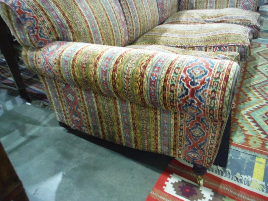 George Smith three-seat sofa in the manner of Howard, vibrantly upholstered, raised upon turned - Image 5 of 6