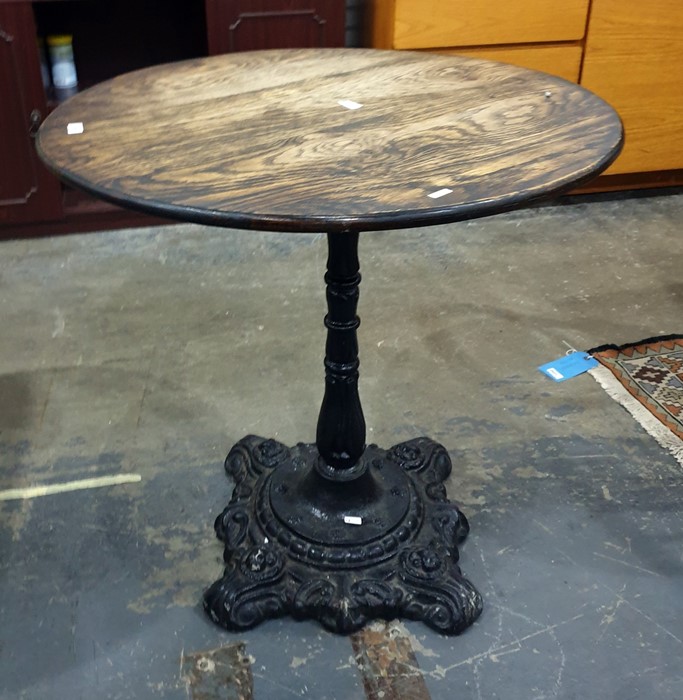 Circular oak-topped pub-type table with cast iron black painted base, 72cm diameter