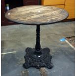 Circular oak-topped pub-type table with cast iron black painted base, 72cm diameter