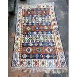 Eastern rug on a brown ground, assorted hooked medallion decoration, in browns, pinks, greens,